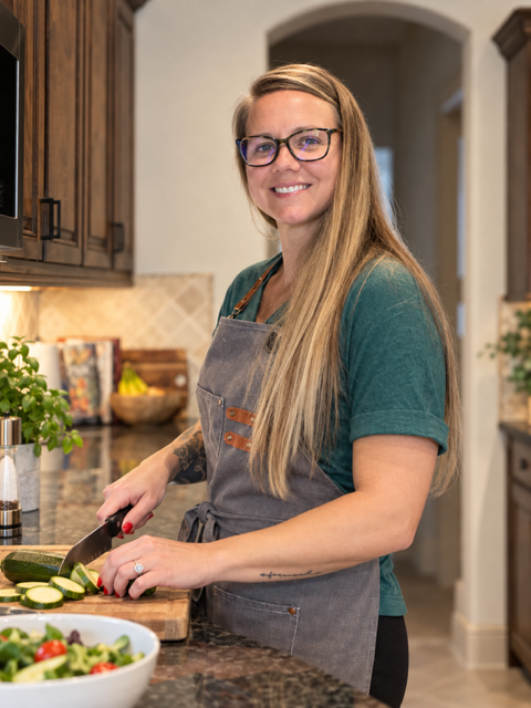 Suzanne Hildebrandt, certified nutrition coach, preparing vegetables in her kitchen